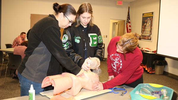 EMT students are reviewing CPR.