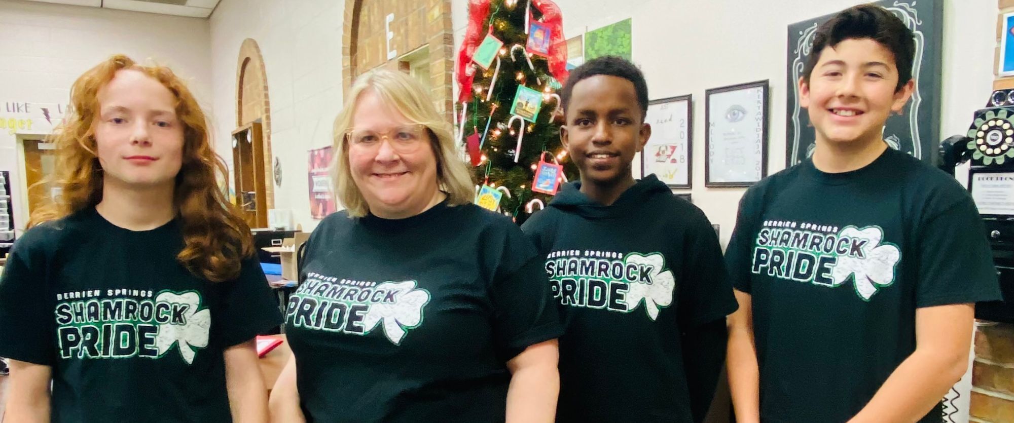 Middle School students and Mrs. Sheline wearing their Shamrock Pride shirts.